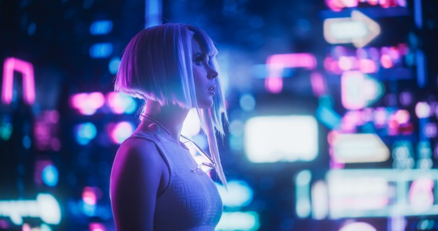 Portrait of an Excited Young Female with Blue Hair Wandering Around a Futuristic Urban Center with Neon Lights and Artificial Intelligence Technology