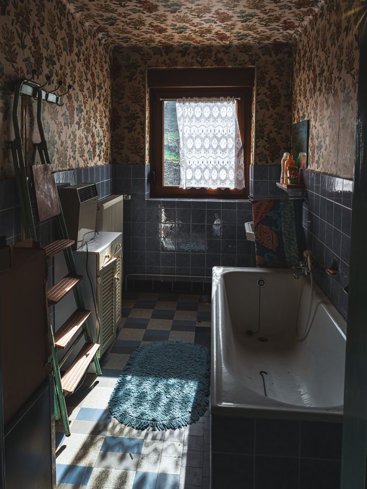 Interior of an old village house. Old furniture, chandelier, bathroom, old things, old dishes, glasses.