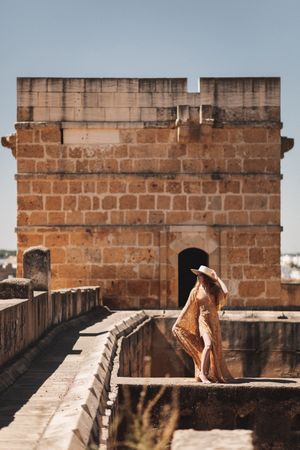 Stylish female on old bridge
