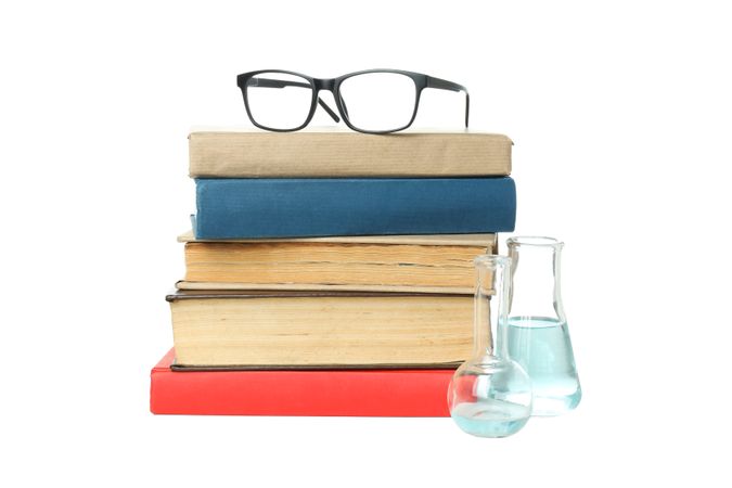 Books, flasks and glasses, isolated on light background