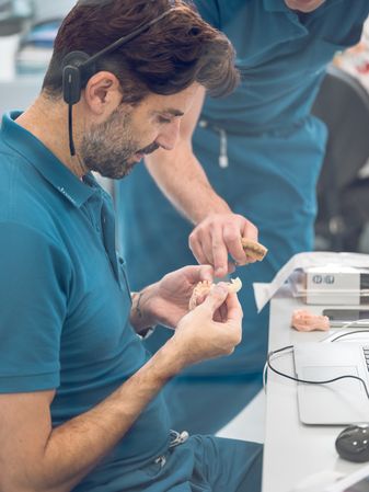 Dental technician making denture in lab