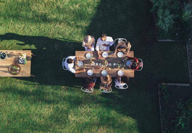 Aerial view of friends enjoying meal at an outdoor party