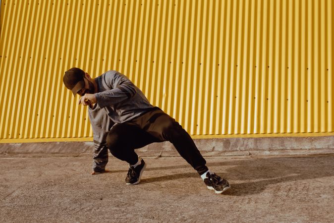 Man performing handstand near wall