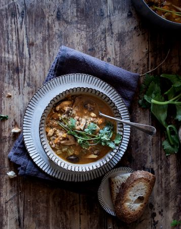 Bread and parsley near quinoa soup