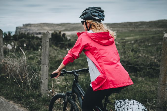Female on bicycle enjoying landscape