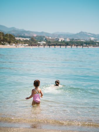 Cheerful girl having fun in warm sea
