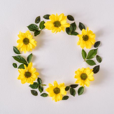 Round wreath with yellow flowers and leaves