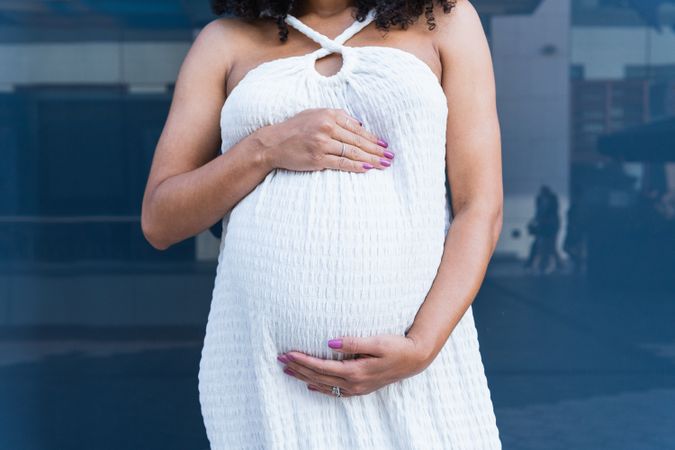 Anonymous pregnant woman in long dress