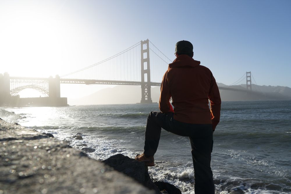 Tourist gazing at scenic bridge at peaceful bay