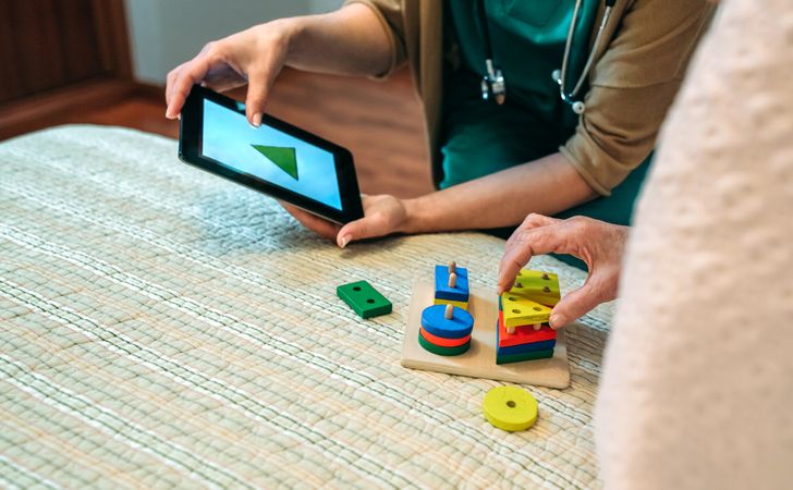 Female doctor showing geometric shapes to patient