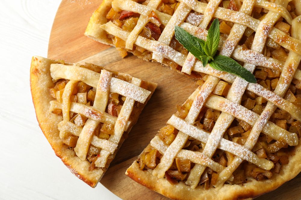 Tasty apple pie on wooden background, top view. Homemade food