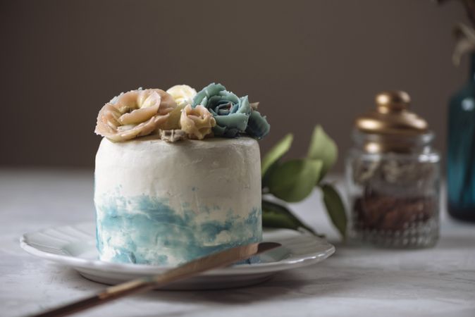 Buttercream flowers cake, blue and pastel peach colors