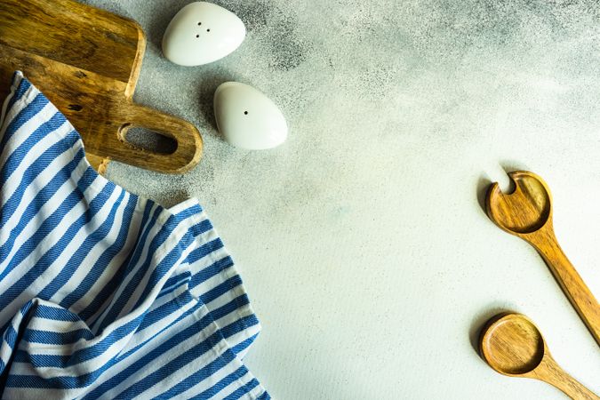 Modern salt and pepper shaker with wooden spoons on kitchen counter with copy space
