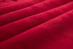 Close up Red folded Fabric Background Texture.