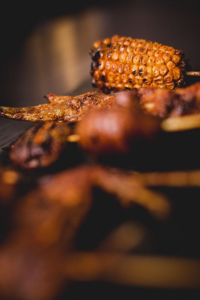 Tasty grilled skewers on table in cafe