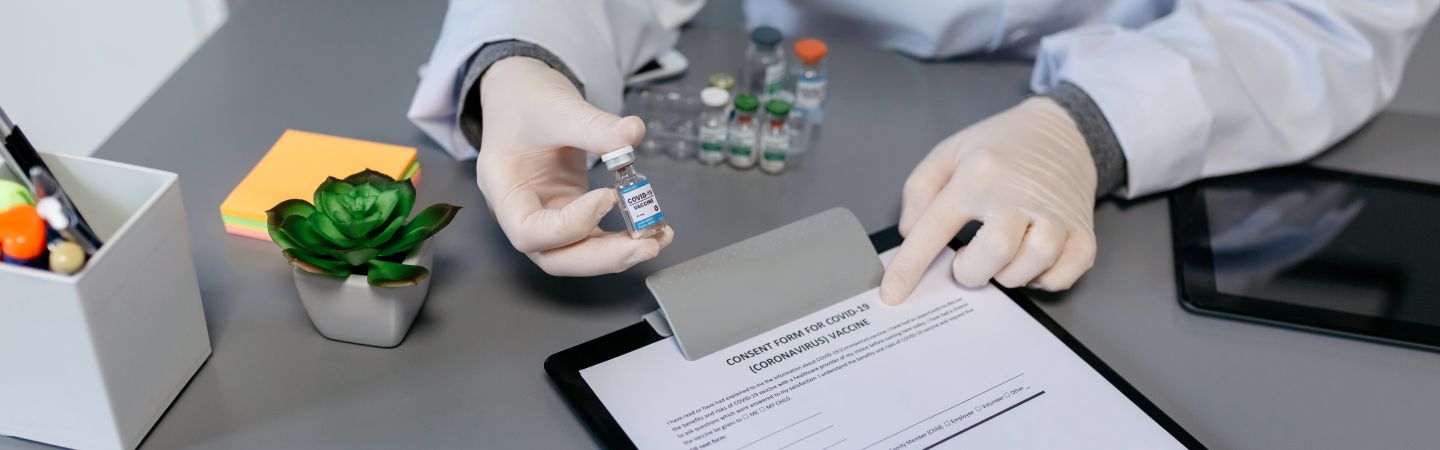 Unrecognizable doctor explaining to her patient the benefits and risks of the coronavirus vaccine
