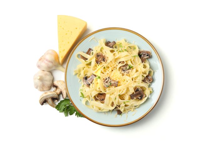 Plate with pasta, cheese and mushrooms isolated on plain background