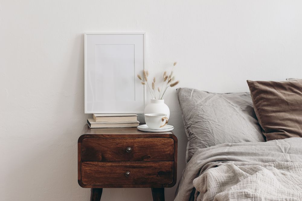 Vertical picture frame mockup on old books in elegant bedroom