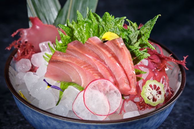 Ceramic plate with raw fish and vegetables