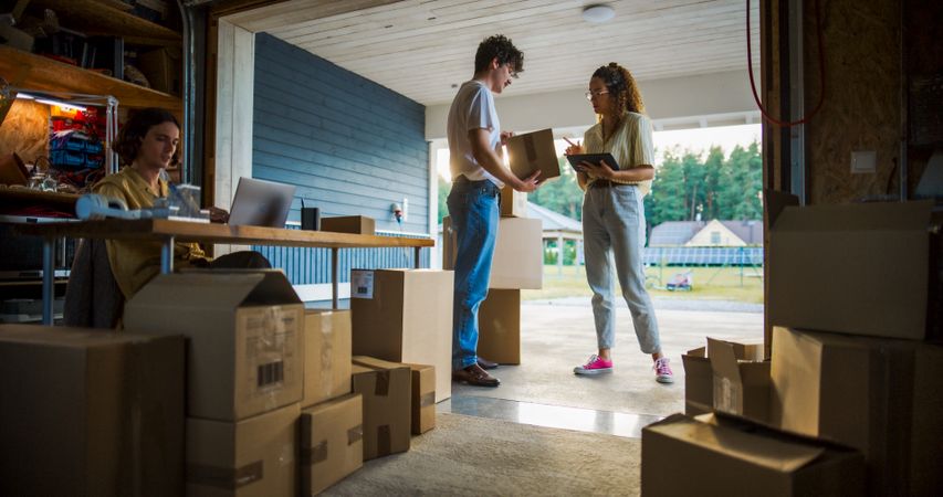 Three Small Business Owners Working In Garage.