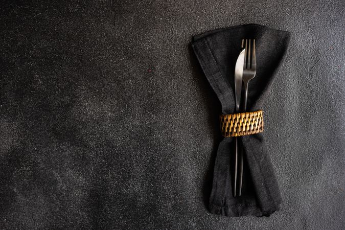 Dark napkin wrapping silverware