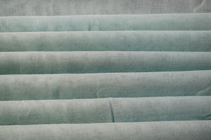 Nude green fabric folded background texture