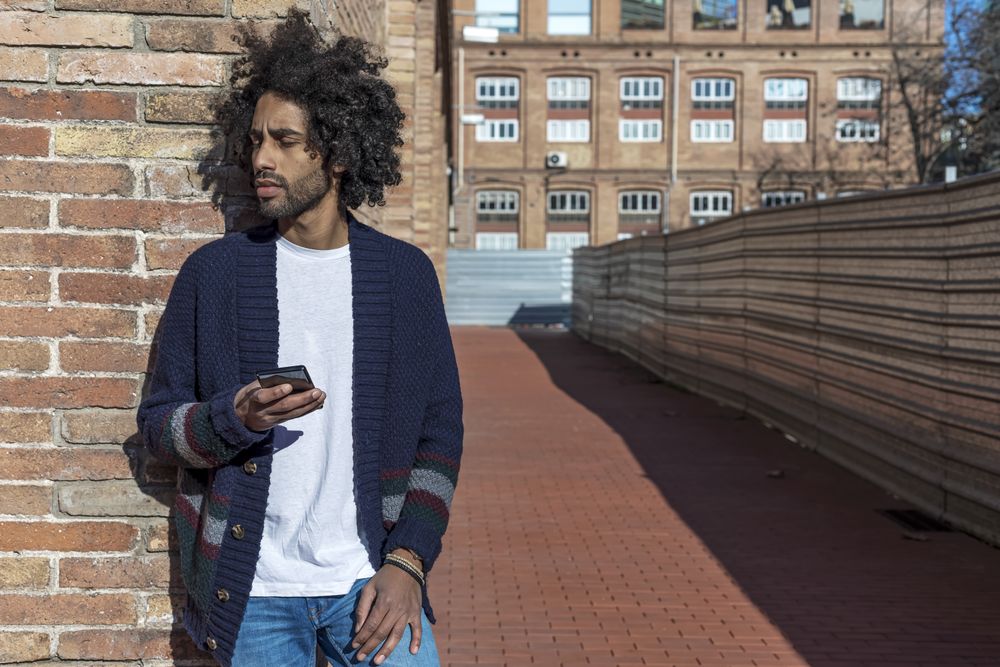 Man using mobile phone on street