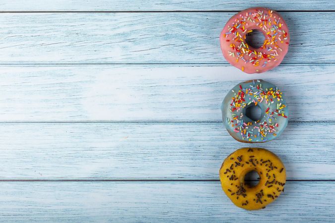 Delicious assorted colorful donuts on the table.