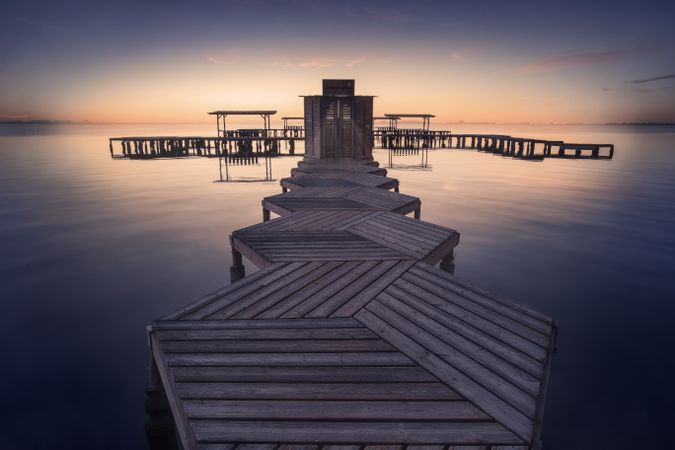 Overwater pier of resort at sunset