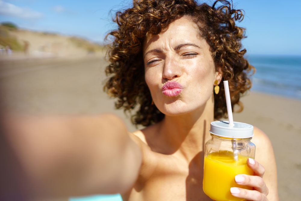 Woman taking selfie at the beach
