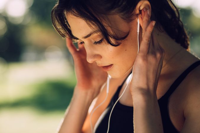 Fitness woman listening to music wearing earphones
