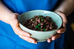 Person holding bowl of beans
