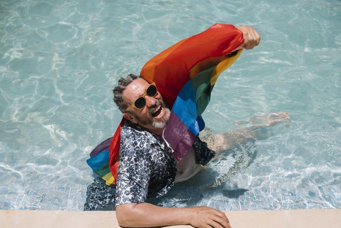 Excited gay man in swimming pool