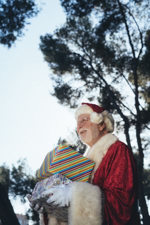 Santa Claus with presents by old van