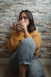 Woman drinking hot tea at home