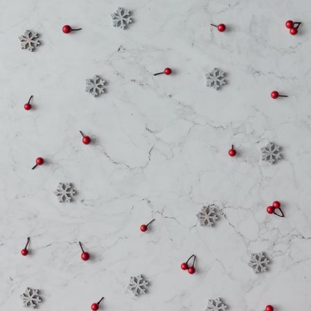 Snowflakes and berry on marble background