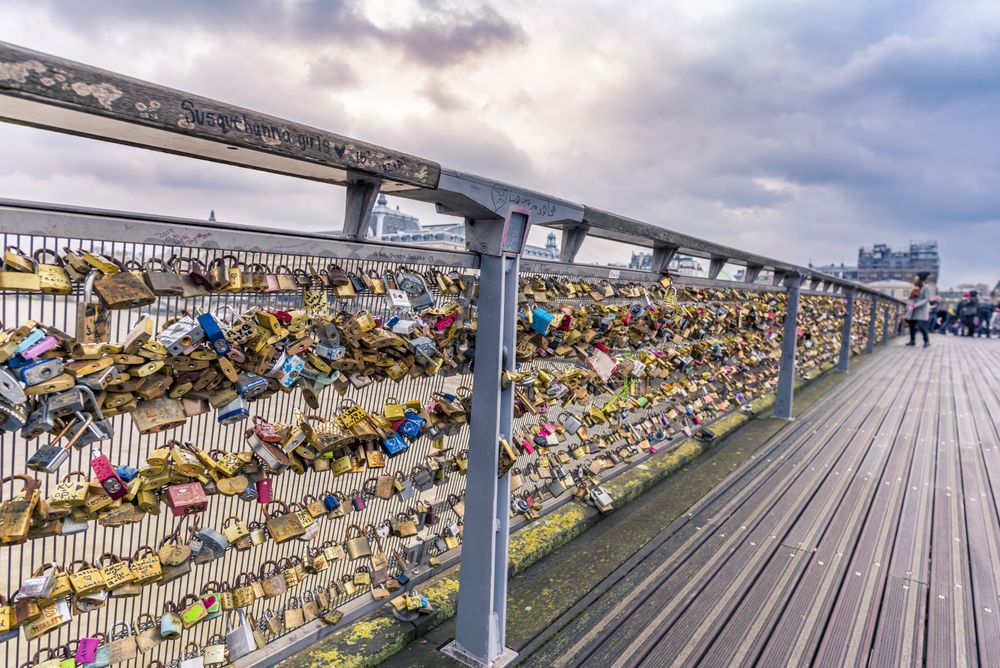 Metal locks caught on the rail of a bridge