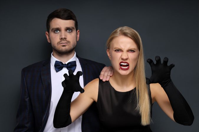 Concept of Halloween, young man and woman on dark background