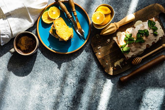 Looking down at coffee served with delicious lemon cake with fresh mint garnish