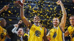 Multiethnic Basketball Players Celebrate Championship Victory with Hugs, Jumping, And Holding the Trophy High.