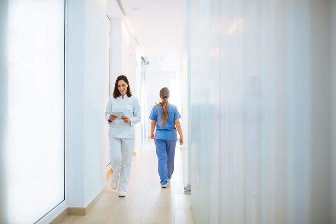 Doctor in white uniform walking along corridor