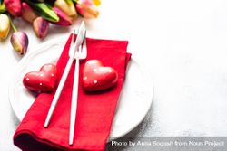 Heart decorations and tulips on table setting 0yXXpa
