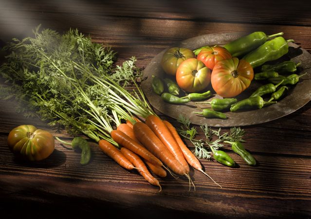 Vegetable still life in sunlight on wooden table
