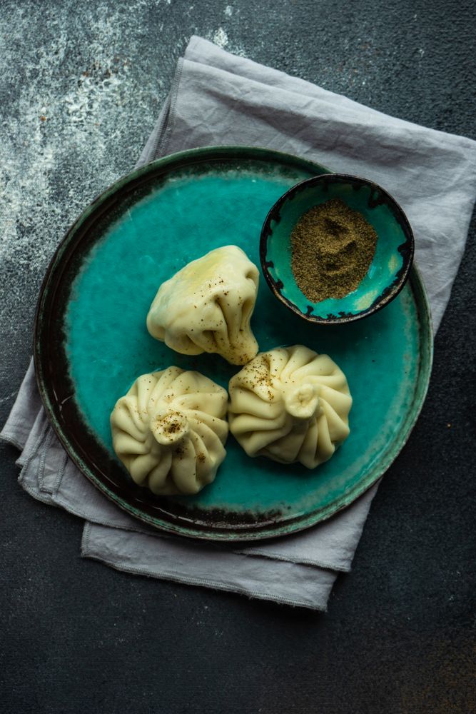 Teal plate with three Georgian khinkali dumplings