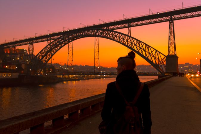 Female walking on embankment during sundown