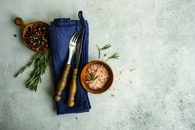 Cooking concept with spices and cutlery with navy napkin