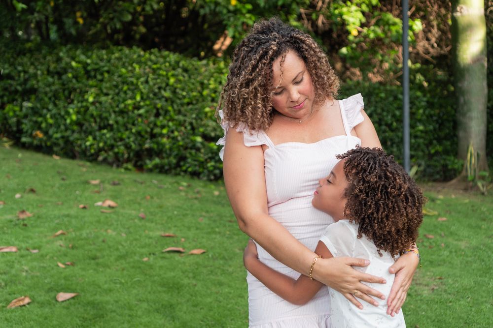 The mother and daughter spend time together outdoors.