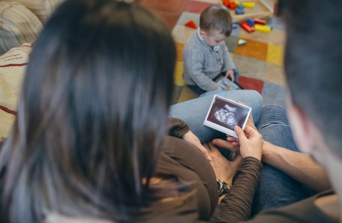 Parents looking at ultrasound of their new baby
