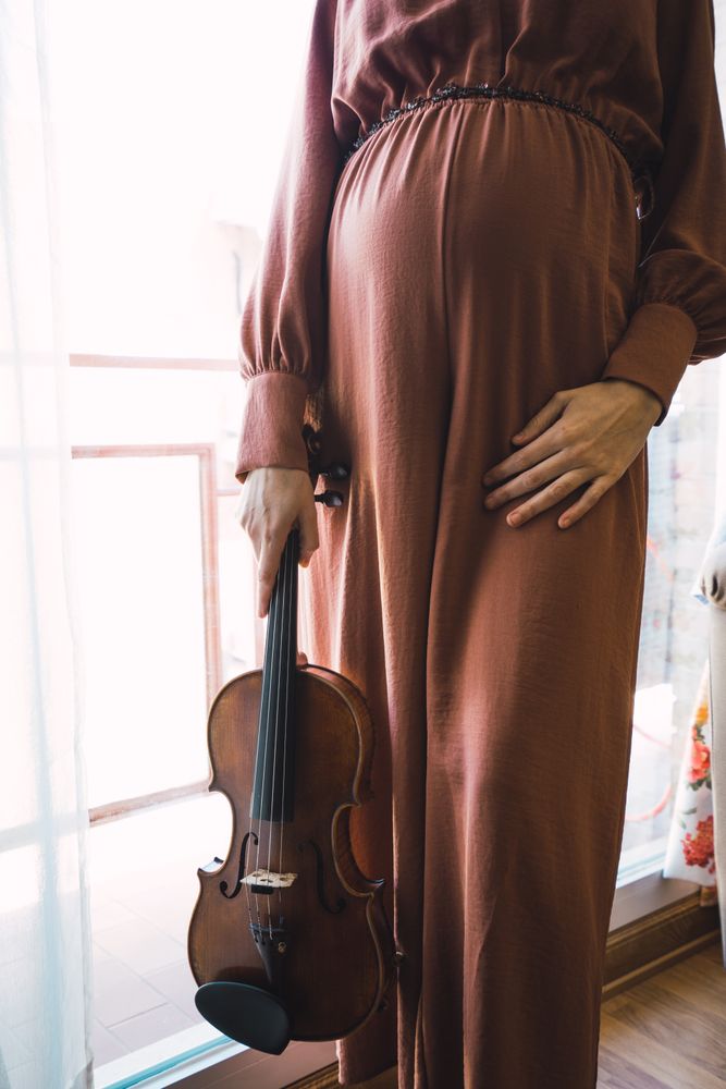 Young smiling woman with violin