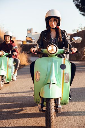 Young people riding motorcycles on city road